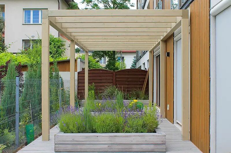 Pergola z drewna klejonego BSH przy tarasie domu jednorodzinnego